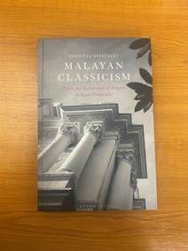 Photograph of a hardcover book entitled Malayan Classicism, with a black and white image of the former Penang Free School and tropical foliage on the cover.