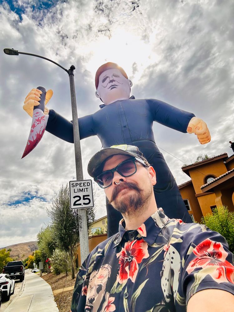 Will taking a selfie in front of massively huge Michael Meyers inflatable Halloween decoration‚ it is taller than the house it is next to.