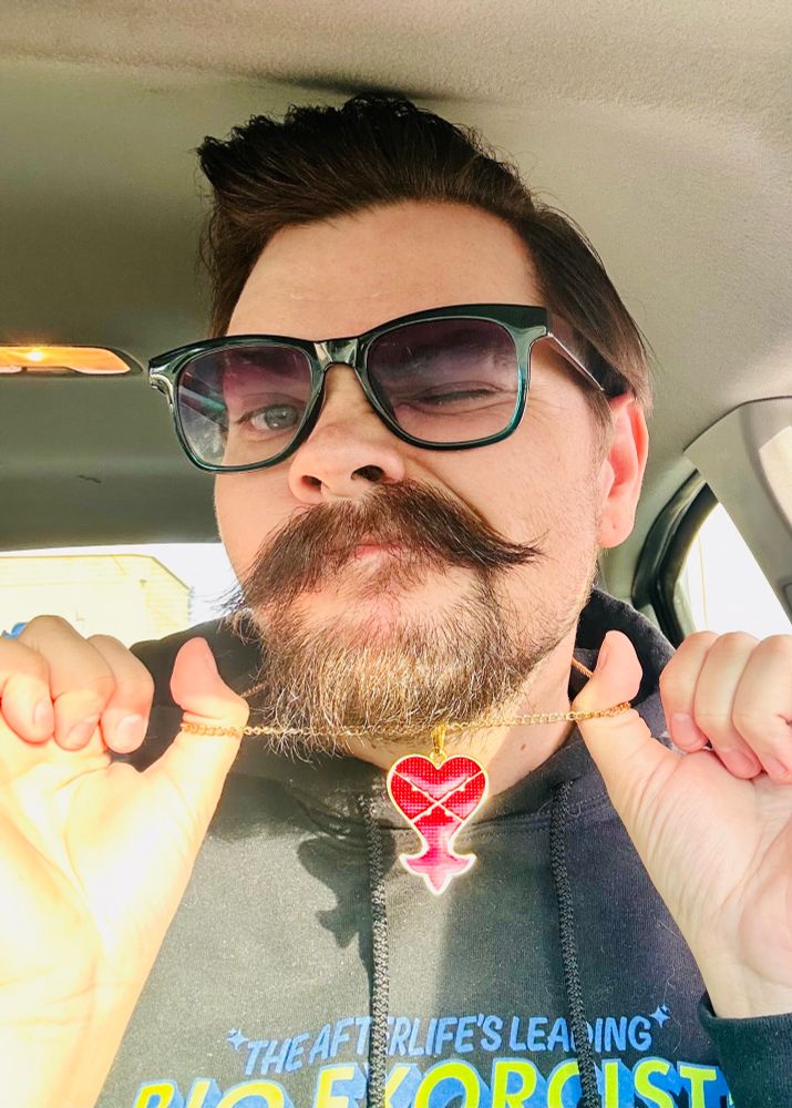 Selfie of Will in his car holding up a necklace with the Heartless symbol from Kingdom Hearts