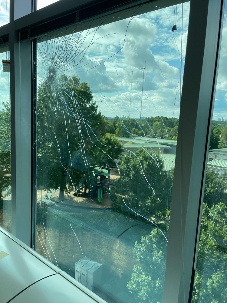 a spider shattered window with bullet hole overlooking the daycare and playground. source from one of the news articles (i forgot which)