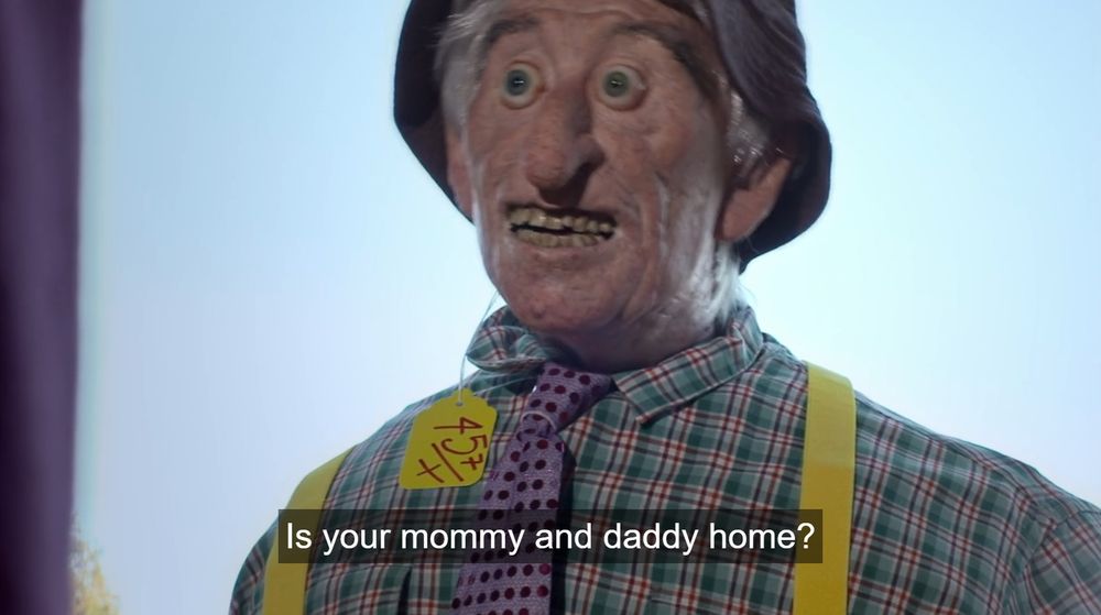 From the film Abruptio. A disturbing puppet of a middle-aged man with bulging eyes and a tag still attached to his fishing hat says "Is your mommy and daddy home?"
