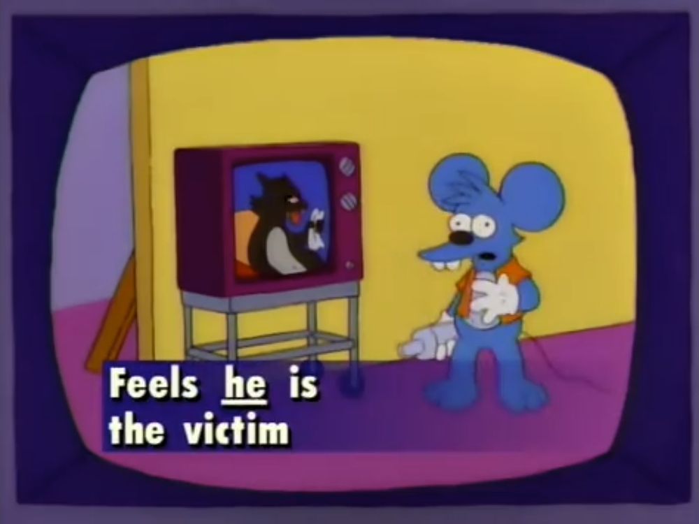 Simpsons screencap from an Itchy and Scratchy episode parodying daytime reality TV. Itchy "backstage" with a forlorn look and a chyron that says "Feels HE is the victim."