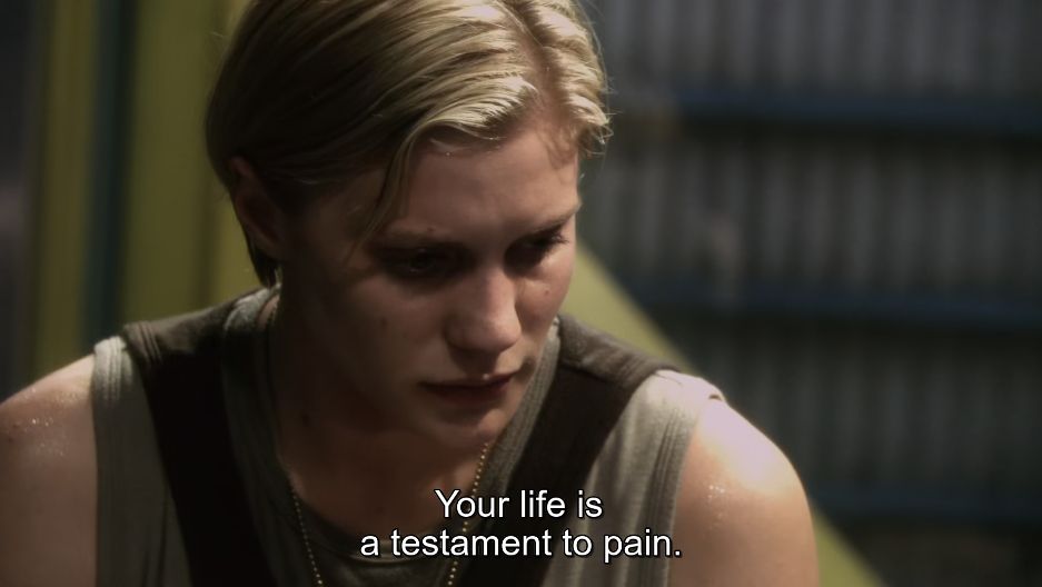 From the show Battlestar Galactica. Starbuck looks downcast while the man she's interrogating tells her "Your life is a testament to pain."