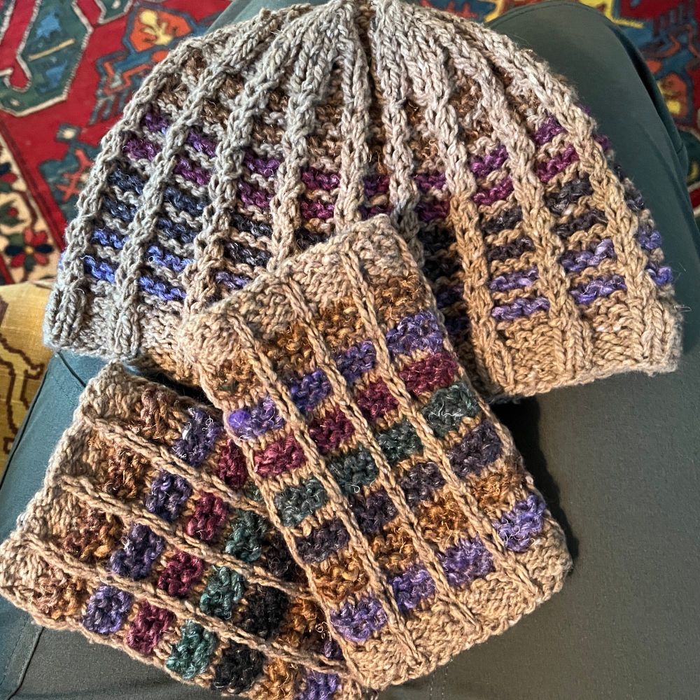 Closeup of a colorful hat and matching fingerless mitts.