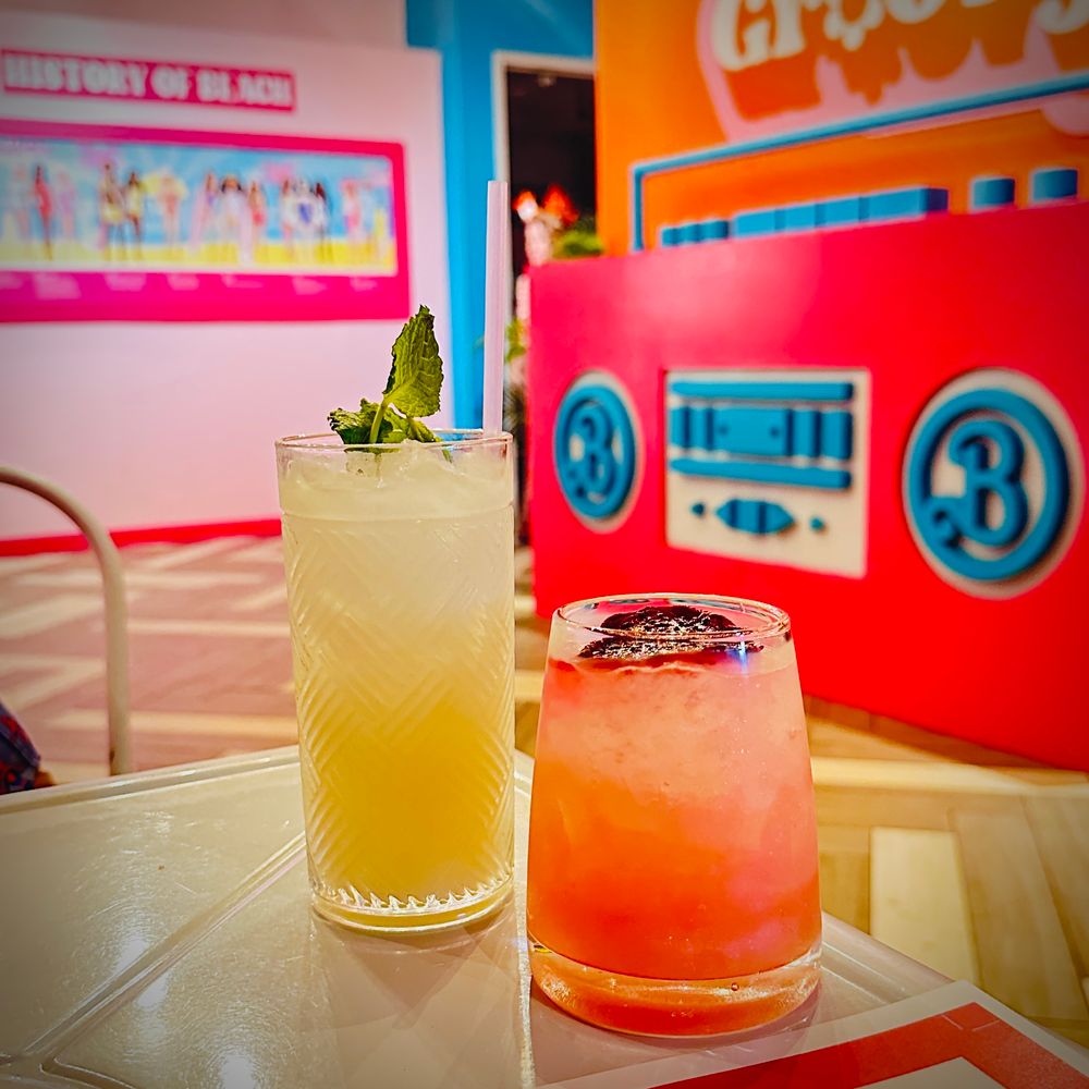 Two bright cocktails against a pink Barbie background 