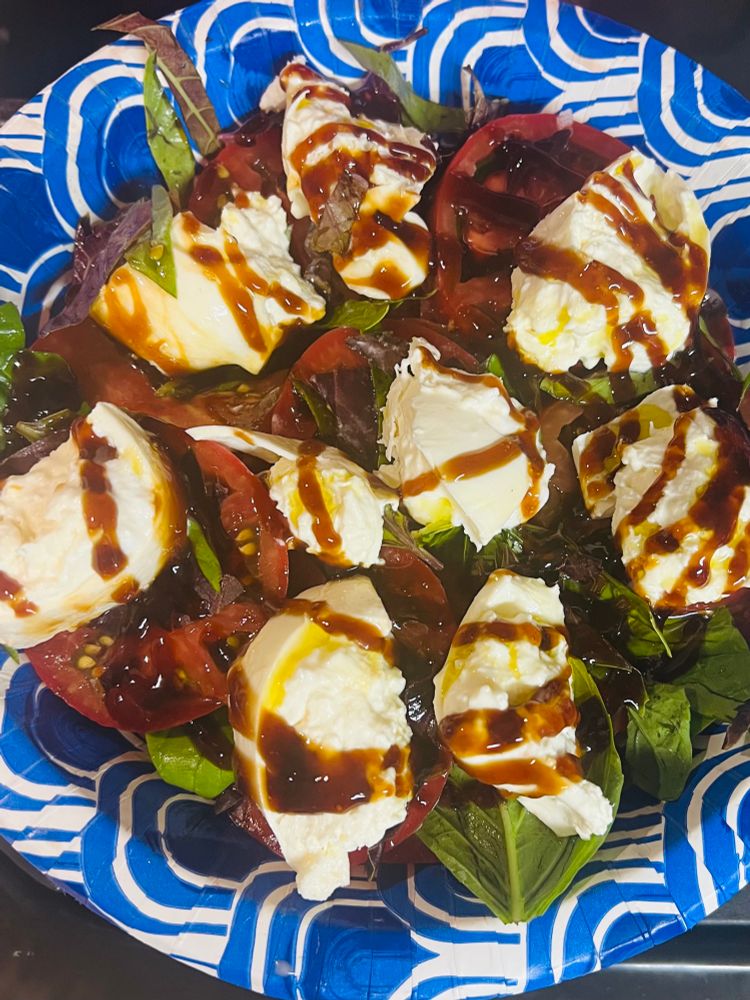Tomato, basil, and buratta with olive oil balsamic glaze and flaky sea salt.