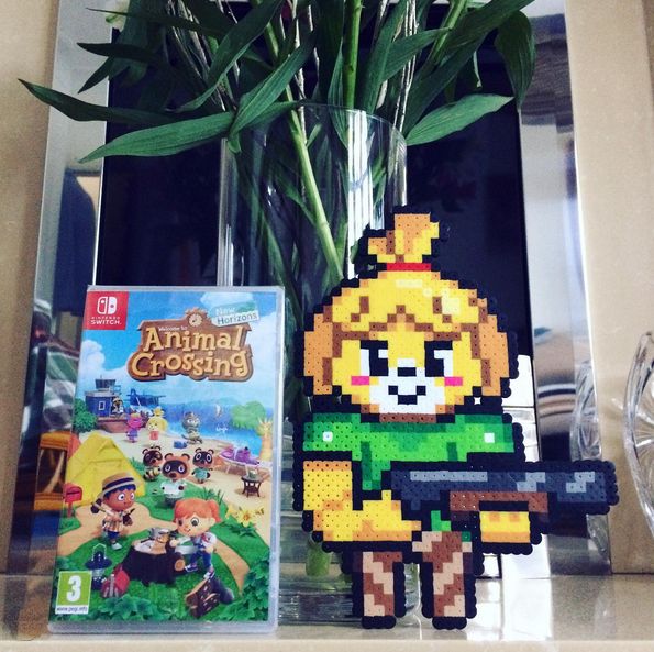 A physical, customized sprite piece I made for the most part (the Isabelle head I found the pattern online) to celebrate the release of Animal Crossing's New Horizons & Doom Eternal's being on the same day and both game genres contrasting each other greatly. Accompanied left of the sprite is the game cover of Animal Crossing New Horizons with the backdrop taken place infront of a vase of flowers (the flowers itself are not visible in shot) and a fireplace. 

Originally uploaded: November 2020