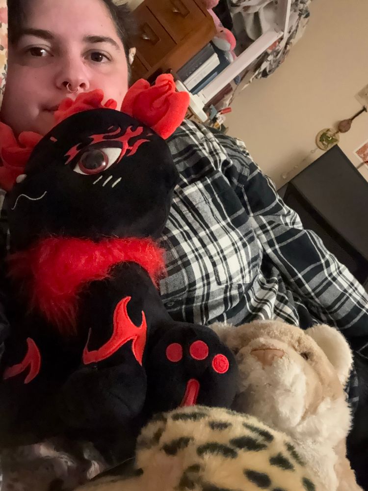 Madeline with stuffed animals in bed 