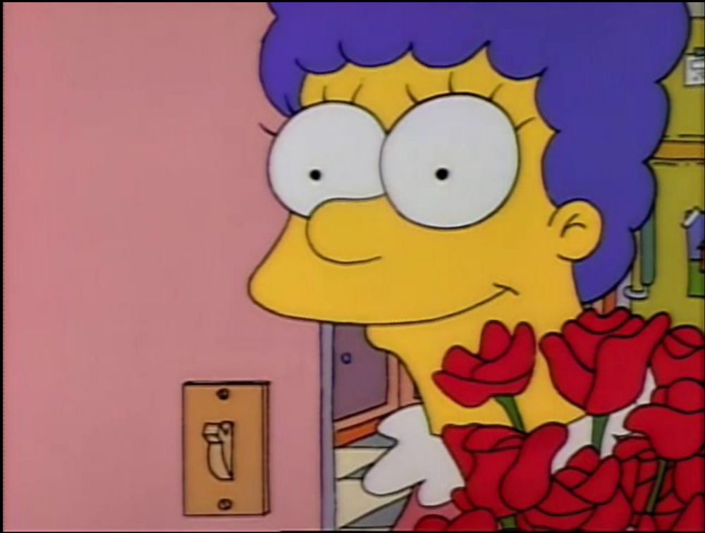 Screengrab of The Simpsons, Marge receiving flowers and smiling