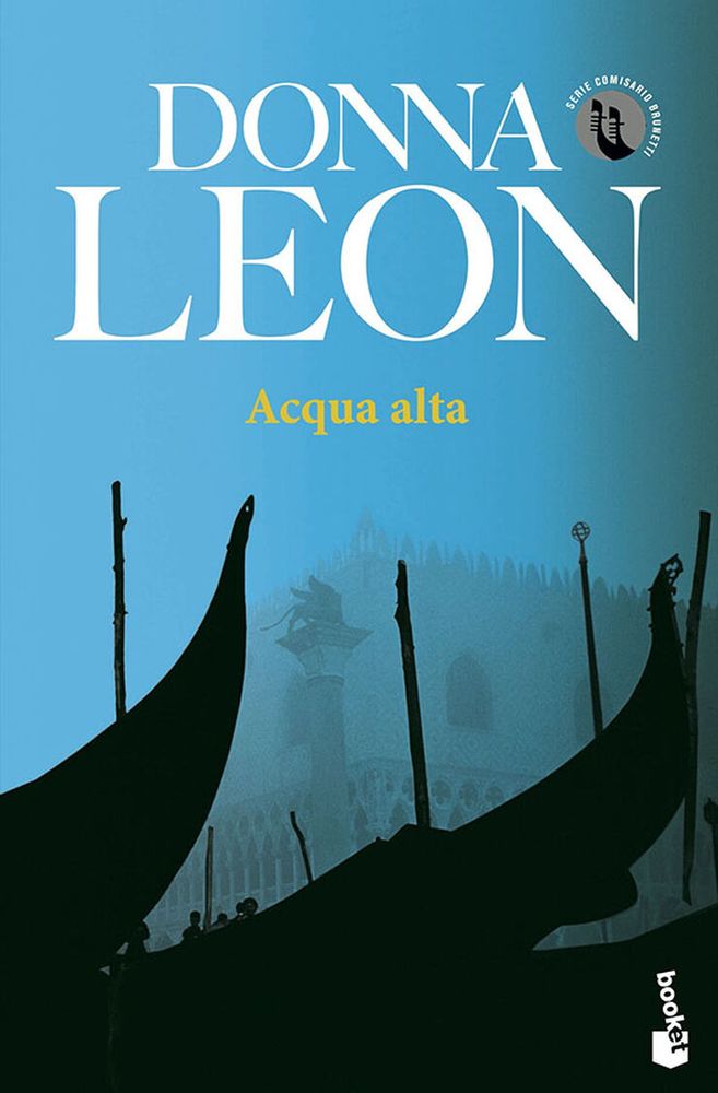 Donna Leon (author) Aqua Alta (title) 

Serie Comisario Brunetti (Italian: Commissario Brunetti Series) 

booket (publisher)

Three gondolas in black shade outline sit in the prominent foreground of the city of Venice, Italy. The Lion of Venice (winged lion) statue appears to be in the background shrouded by mists.    

Text on light blue background in white and yellow. 
