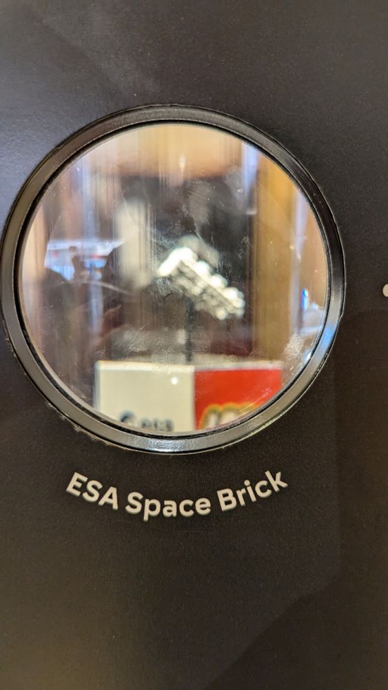 A display at the LEGO store at Disney Springs has a brick printed out of real meteorite. In this photograph, the focus is on the label, which says ESA Space Brick.