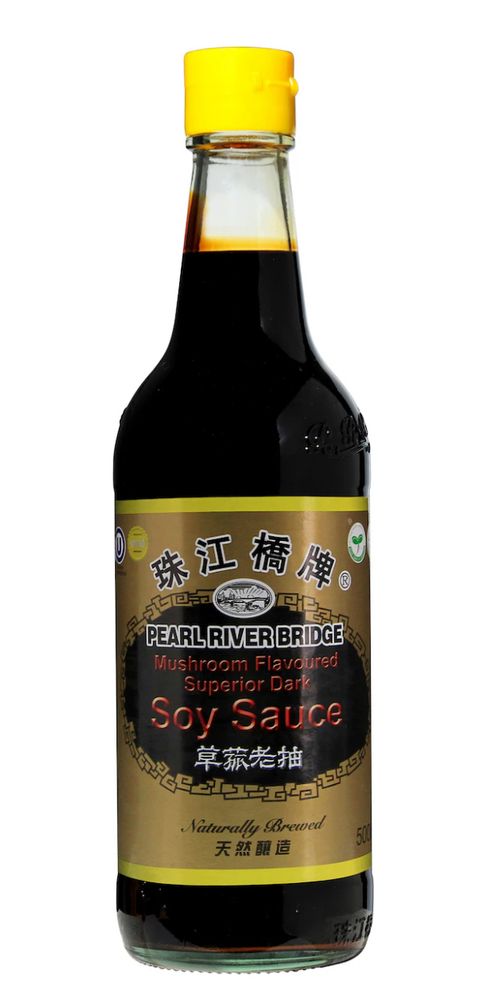 A bottle of Pearl River Bridge Mushroom Flavoured Superior Dark Soy Sauce. The bottle has a yellow cap and a gold label with black and red text. The label includes Chinese characters, the Pearl River Bridge logo, and the words “Naturally Brewed” along with “500ml.”