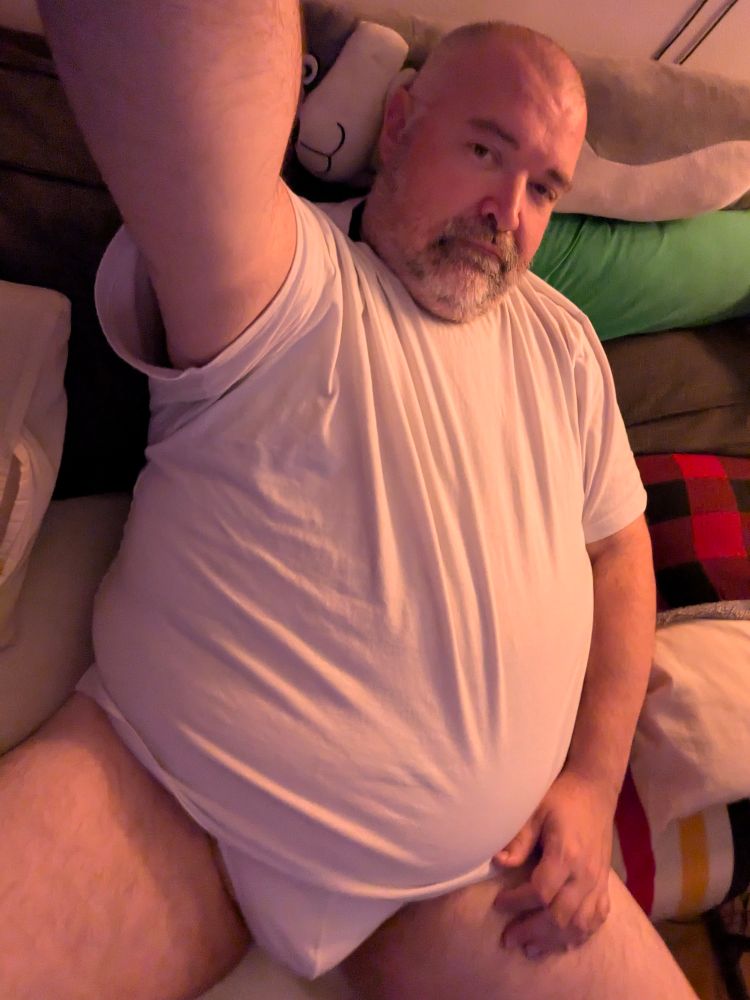 A fat man in tighty whities and a white t shirt