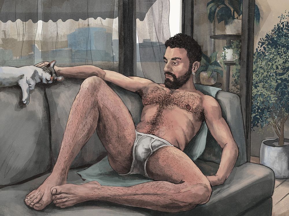 a man sitting on a sofa and petting a cat