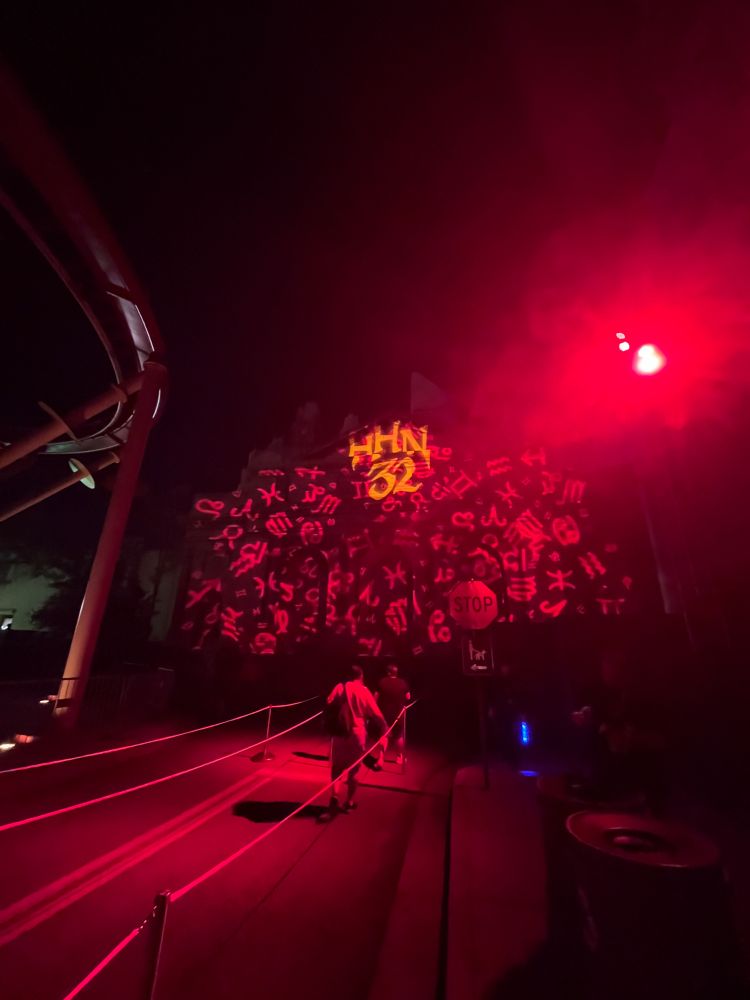 Projection of the zodiac symbols and HHN 32 on a building inside universal studios Orlando