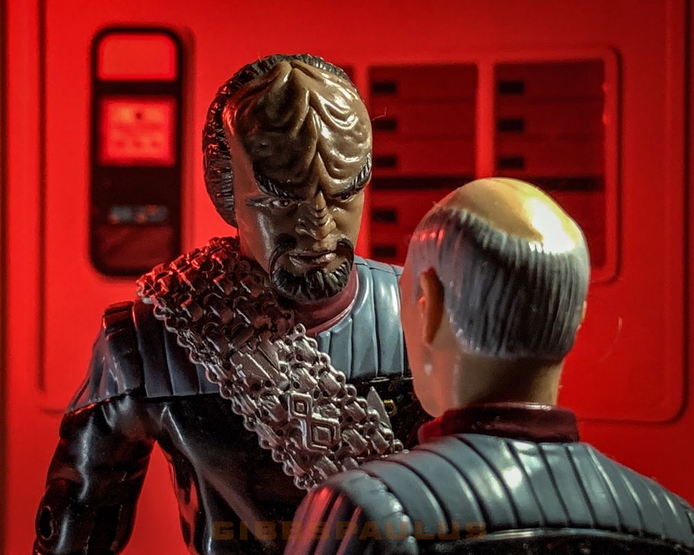 Mr Worf, a tall, humanoid alien, towering over Cpt Picard, a white, man. 

In Star Trek First Contact