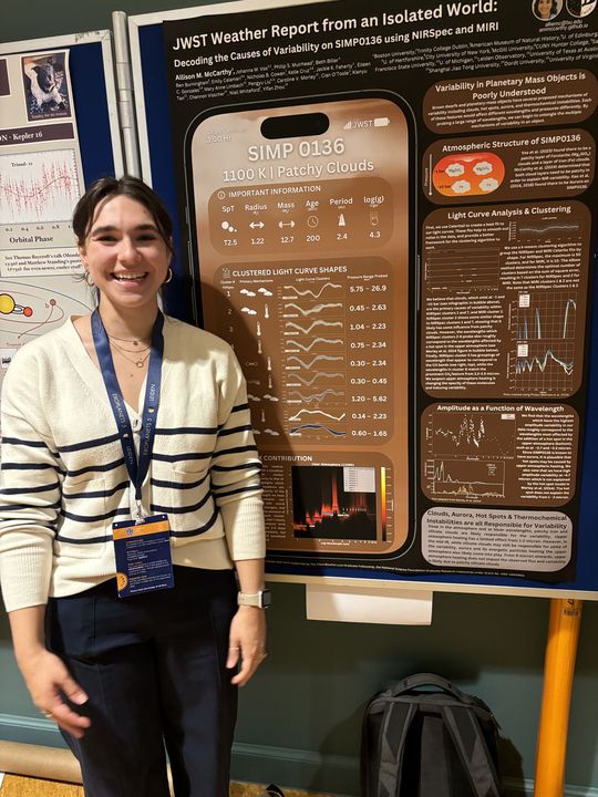 Allison McCarthy standing in front of her poster at Exoplanets V.