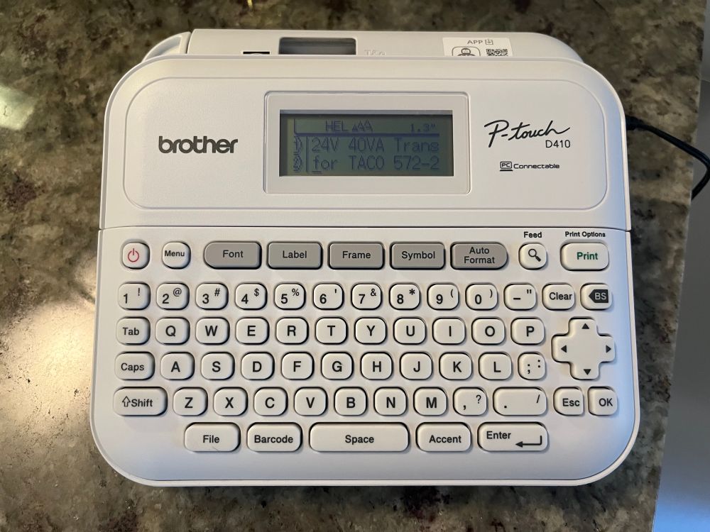 A label maker sitting in a kitchen counter. 