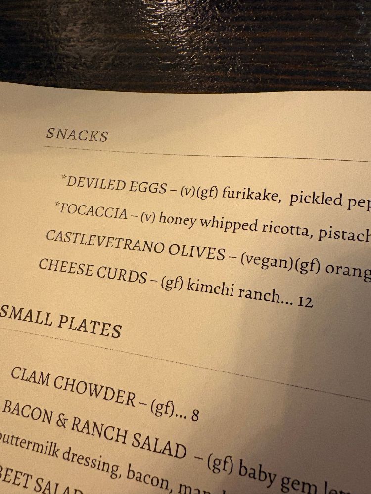 A close-up shot of a tapas menu reading, among other things, Castlevetrano Olives which I initially misread as Castlevania Olives.
