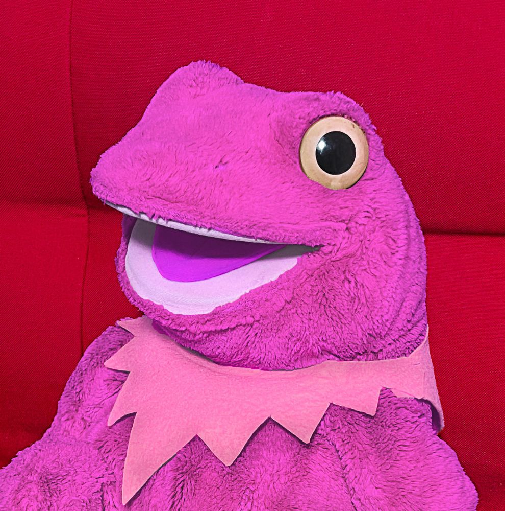 A neon/hot pink plush frog