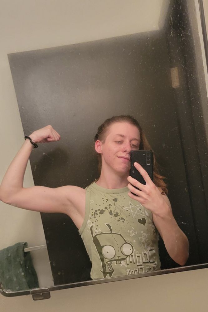 Spiit standing in the bathroom mirror flexing