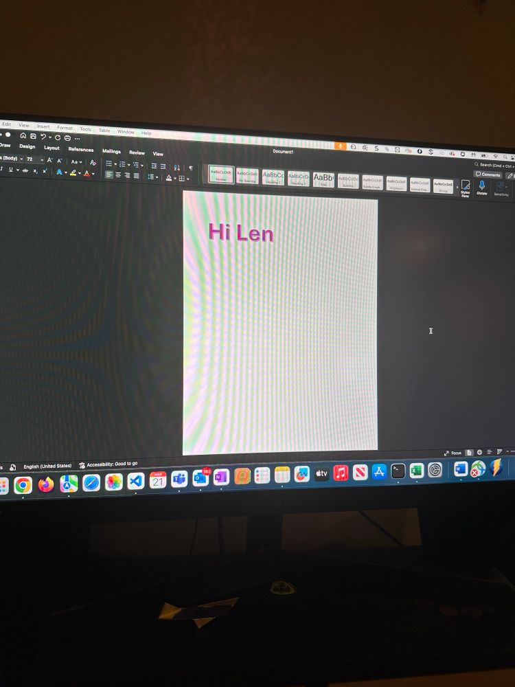 A picture of a monitor, with Word open, with text that reads “Hi Len”