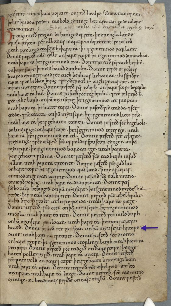 11th-century manuscript page: full page of Old English text, single column of long lines in black ink with red initial H near the top. Prickings clearly visible at outer margin near the page edge. Purple arrow added by me points to the line about St. Wigstan nine lines from the bottom.