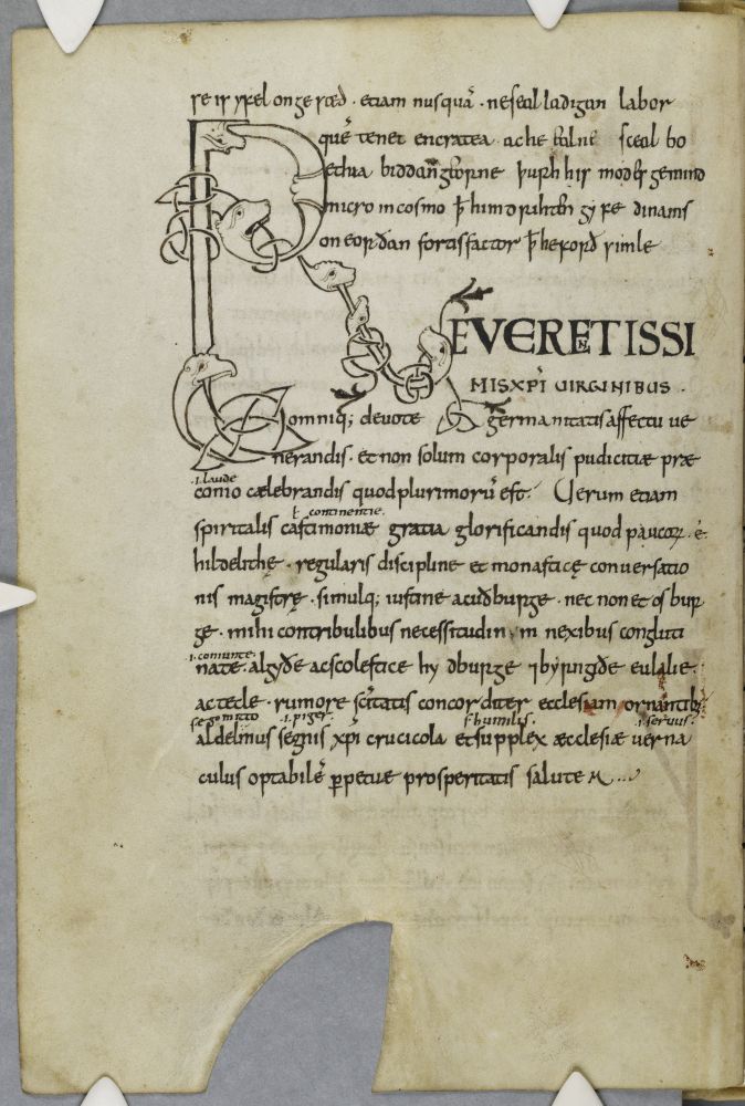 Manuscript page in black ink with very elaborate R initial with biting, interlaced beasts, in the same ink as the main text.