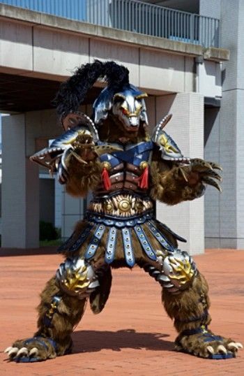 Western Yokai Wolf Man, wolf monster of the week from from Shuriken Sentai Ninninger in an imposing stance, big pawed and clawed hands raised, mostly his torso and top of head covered in armor, his chest sporting red tassels in place to where his nipples could be, with his arms and legs mostly exposed, big footpaws poking through the straps of his roman-styled sandals