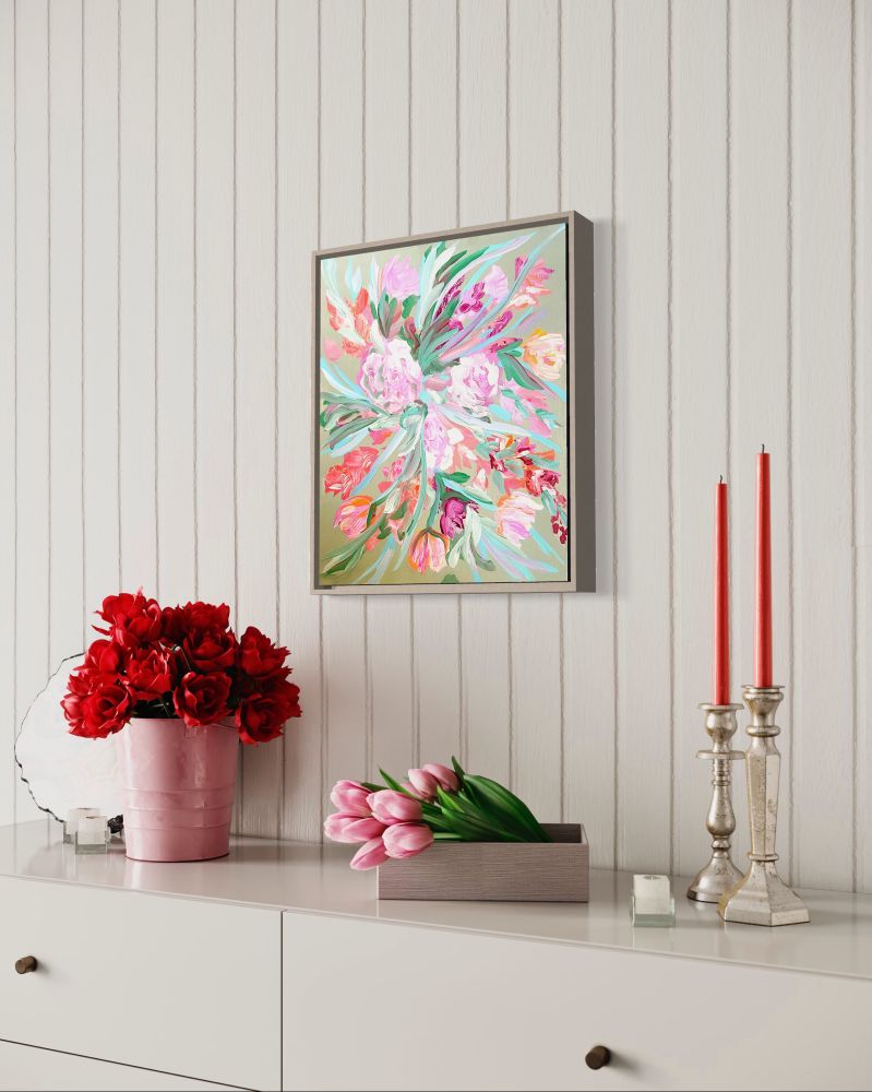 A large acrylic painting of warm-toned, abstract flowers on canvas staged above a dresser with red roses, pink tulips, and red candlesticks.