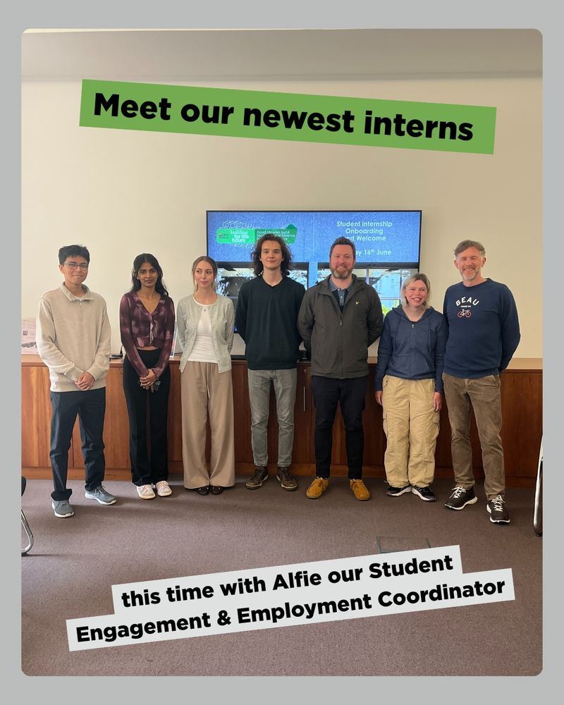 A group photo showing seven individuals standing in a line indoors. Behind them is a screen displaying the text 'Student Internships Orientation Welcome' and '14th June.' A green banner at the top reads 'Meet our newest interns,' and a white banner at the bottom says, 'this time with Alfie our Student Engagement & Employment Coordinator.