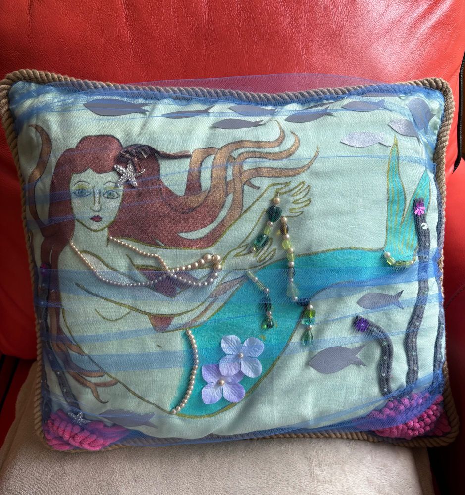 This pillow I made for my nice niece of a sea green mermaid. Painted on fabric, and adorned with sewn on seaweed, coral, schools of silver fish, pearls, glass beads and a sparkling starfish, under blue tulle water