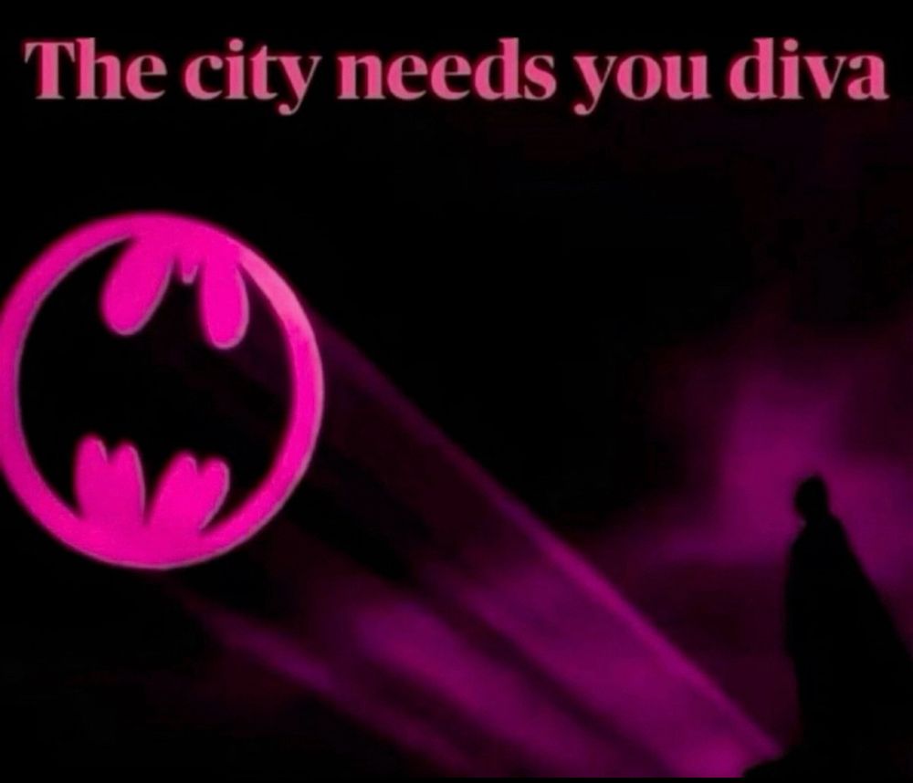 A pink bat-signal in the night sky with text above reading 'The city needs you diva.' A silhouetted bat-like figure stands to the right.