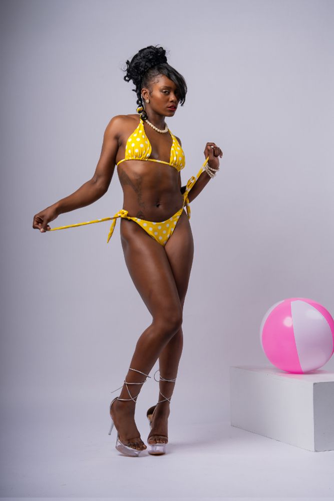 pose reference of a woman in a yellow bikini.