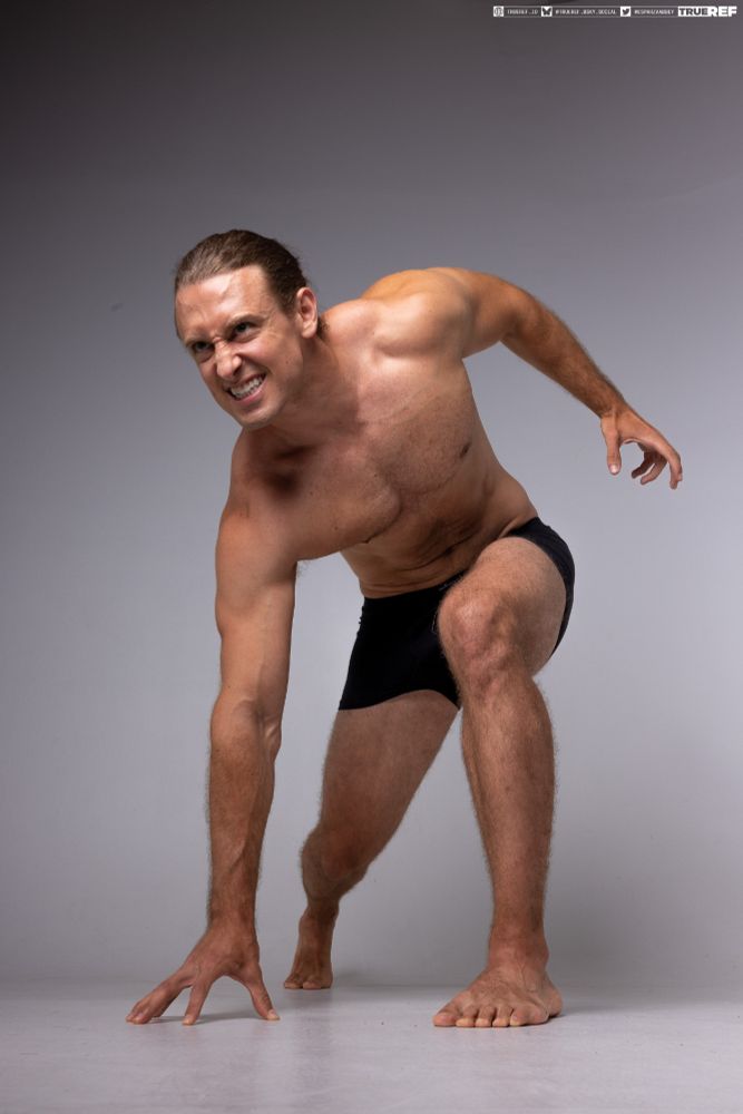 Art pose reference of a man crouching. 