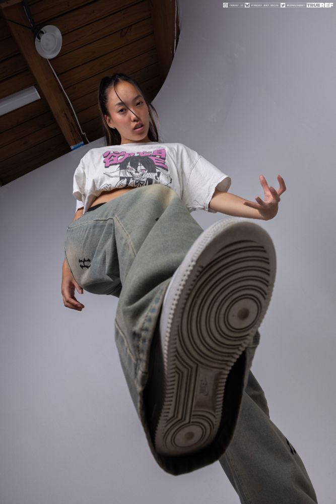 Art pose reference of a woman in street clothes. 