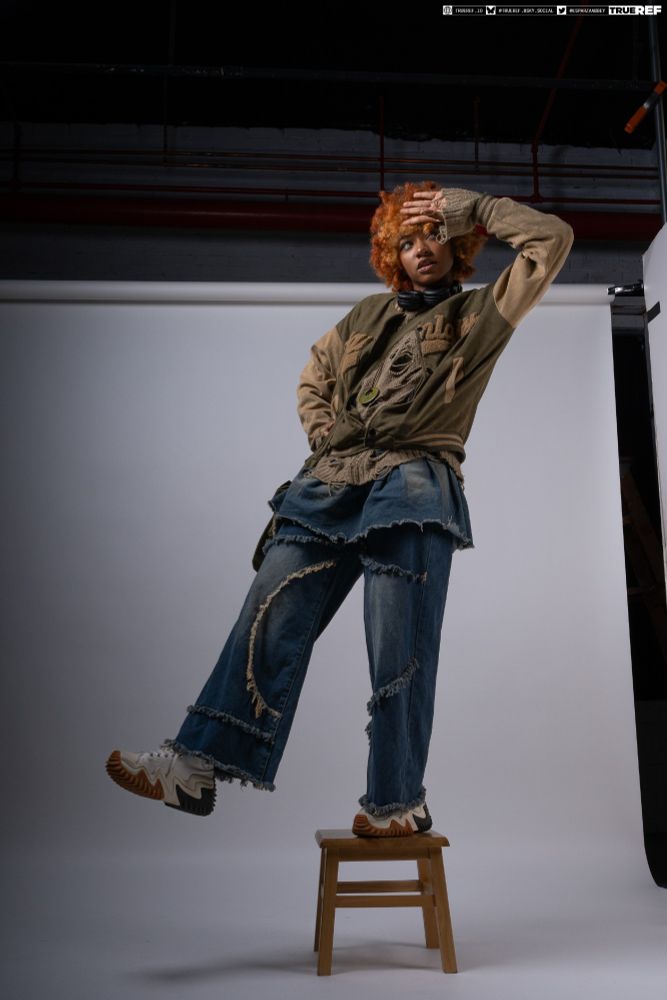pose reference of a woman standing on one leg looking into the distance. 