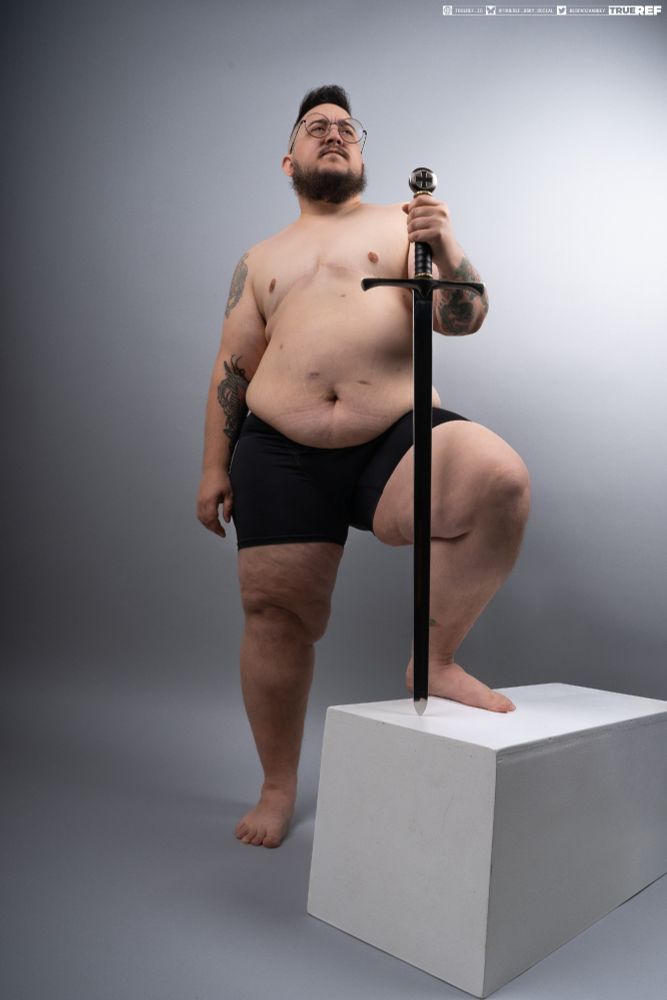 Pose reference of a man standing proudly with a sword. 