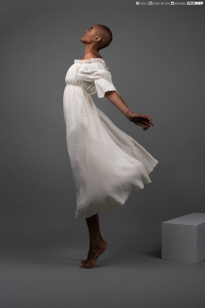 Pose reference of a woman in a vintage white gown. 