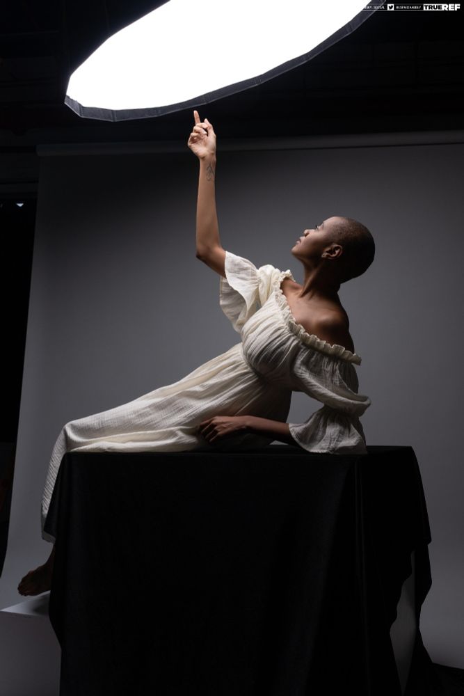 Pose reference of a woman laying down and reaching up to the sky. 