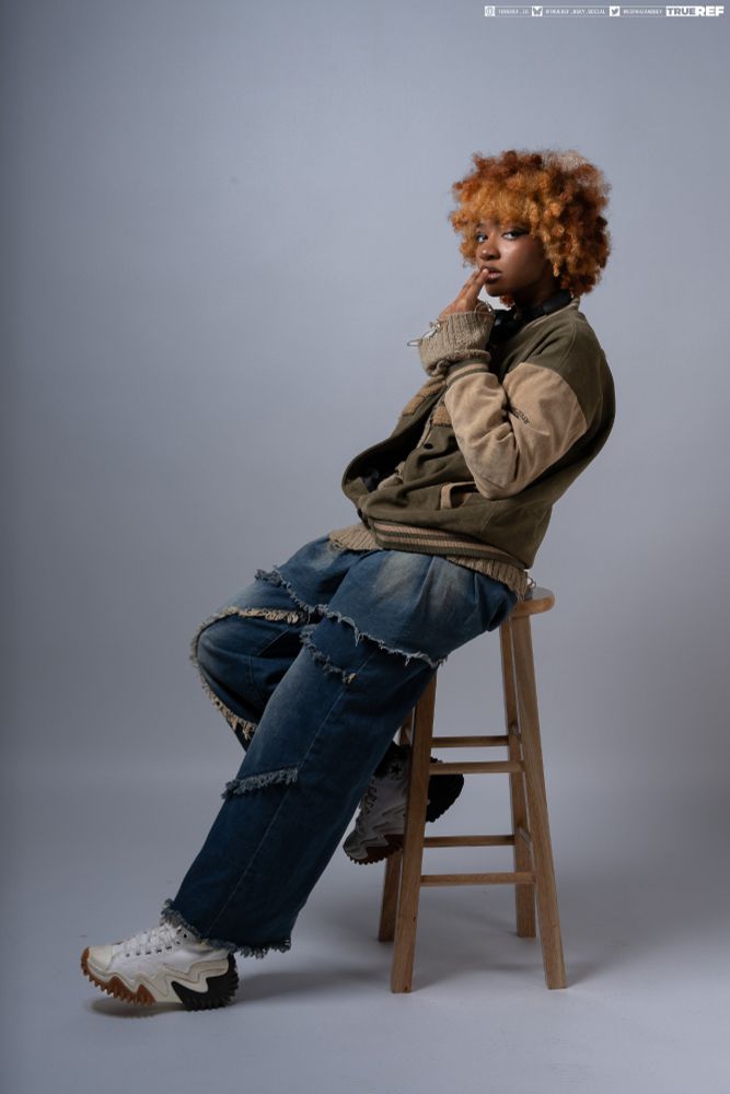 Pose reference of a woman sitting while smoking.  