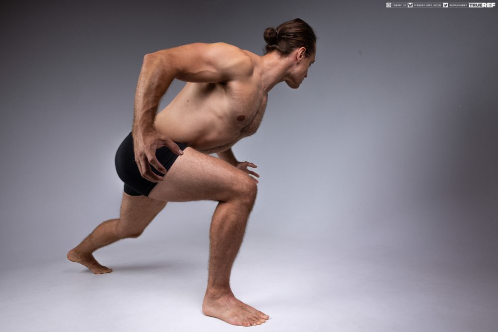 Art pose reference of a man lunging forward.  