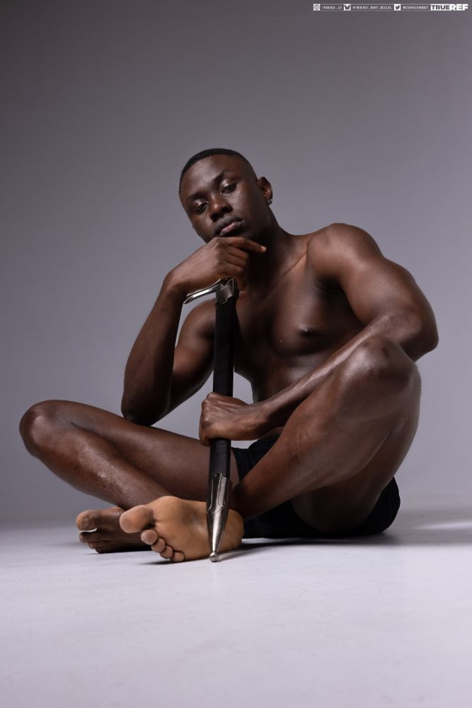 Art pose reference of a man sitting while holding a sword. 