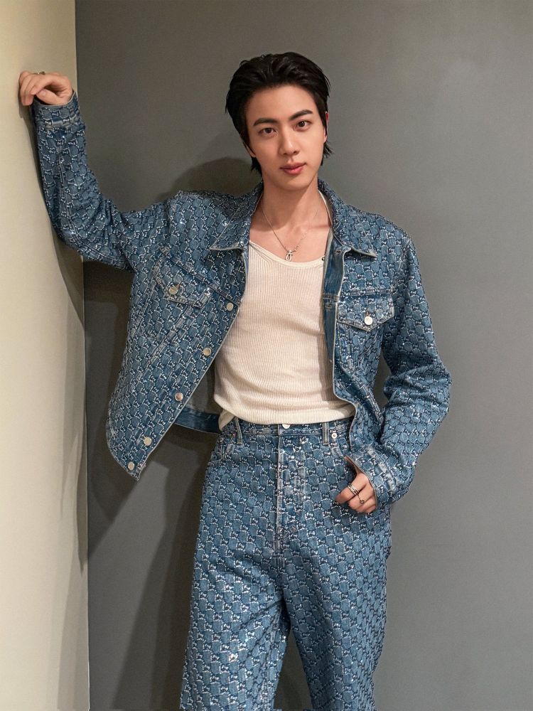 Seokjin leaning against the wall in his coordinated Gucci outfit