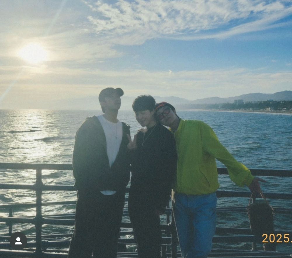 Namjoon Jimin and Hobi standing by what seemed like a dock overlooking the beach