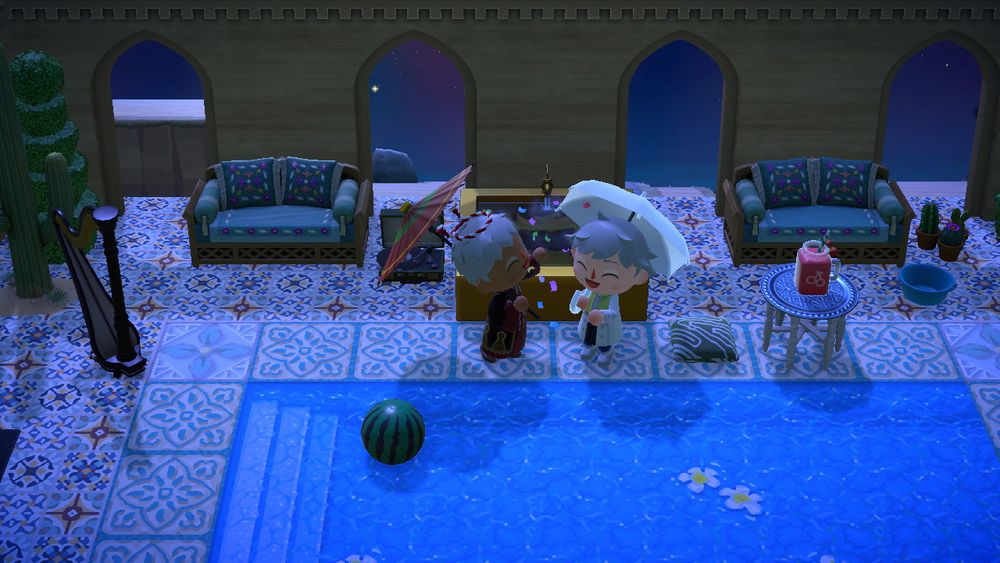 Animal Crossing New Horizons.
My ‘mayor’ is dressed up as Clear, from DRAMAtical Murder. Umi’s ‘mayor’ is dressed as a New Year’s Variant of Kalim, from Disney’s Mobile Game: Twisted Wonderland.
We are seen throwing confetti, and clapping our hands in the photo.