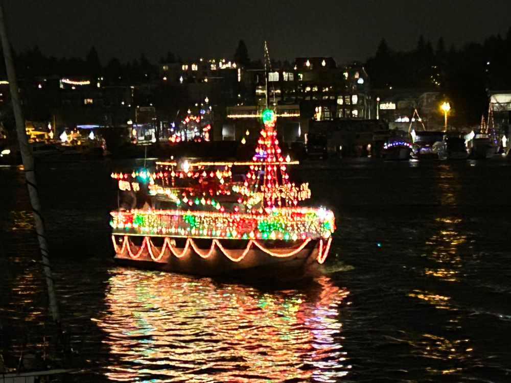 Boat decorated in red and green Christmas lights