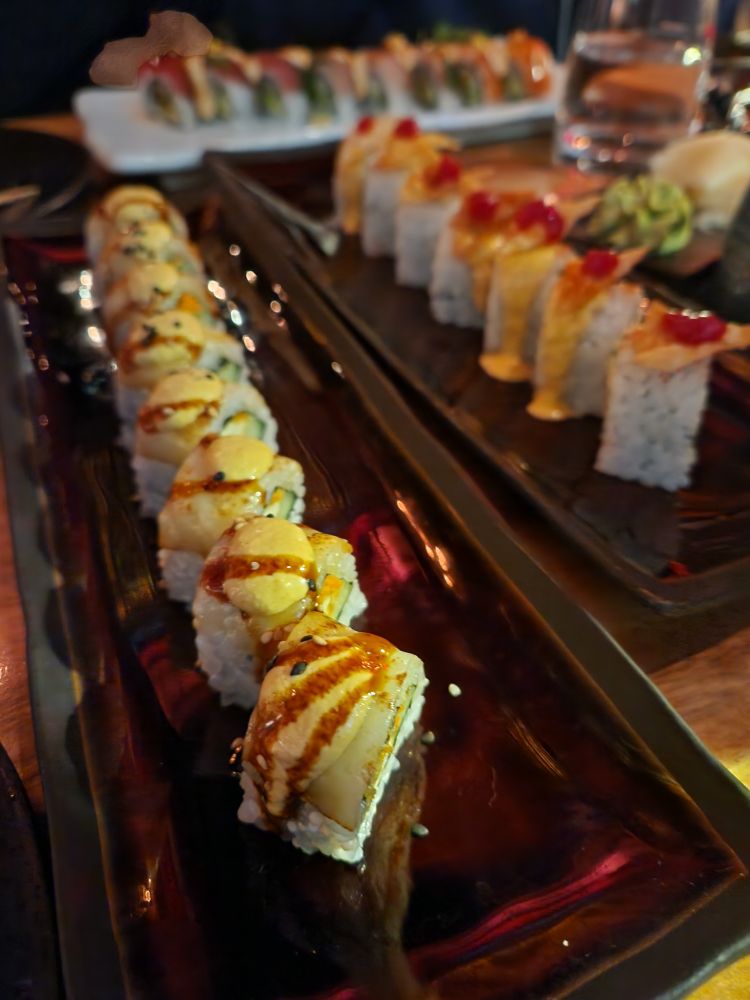 Three plates full of delicious sushi rolls. 