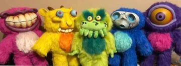 image of 5 scary looking plush dolls from the Starkid theater troupe's "Hatchetfield" universe. From left to right, there's Nibbly (pink with teeth), Tinky (yellow goat thing), Wiggly (green with tentacles), Pokey (blue with a cracked mask), and Blinky (purple with one giant eye). Afaik the only one ever sold to the public was Wiggly for a limited run, and the other four are 1 of a kind prototypes that recently sold through Starkid's kickstarter. Starkid did do chibi versions but these are sold out too.