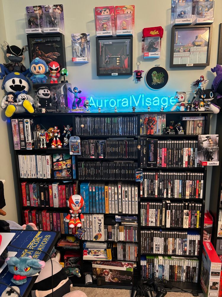 A large shelf of retro games. Several plushies and figures are also on the shelves. 